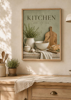 Sage green Kitchen gather cook enjoy artwork with herbs, ceramic jug, mixing bowl, wooden utensils, bread and garlic styled in a farmhouse kitchen