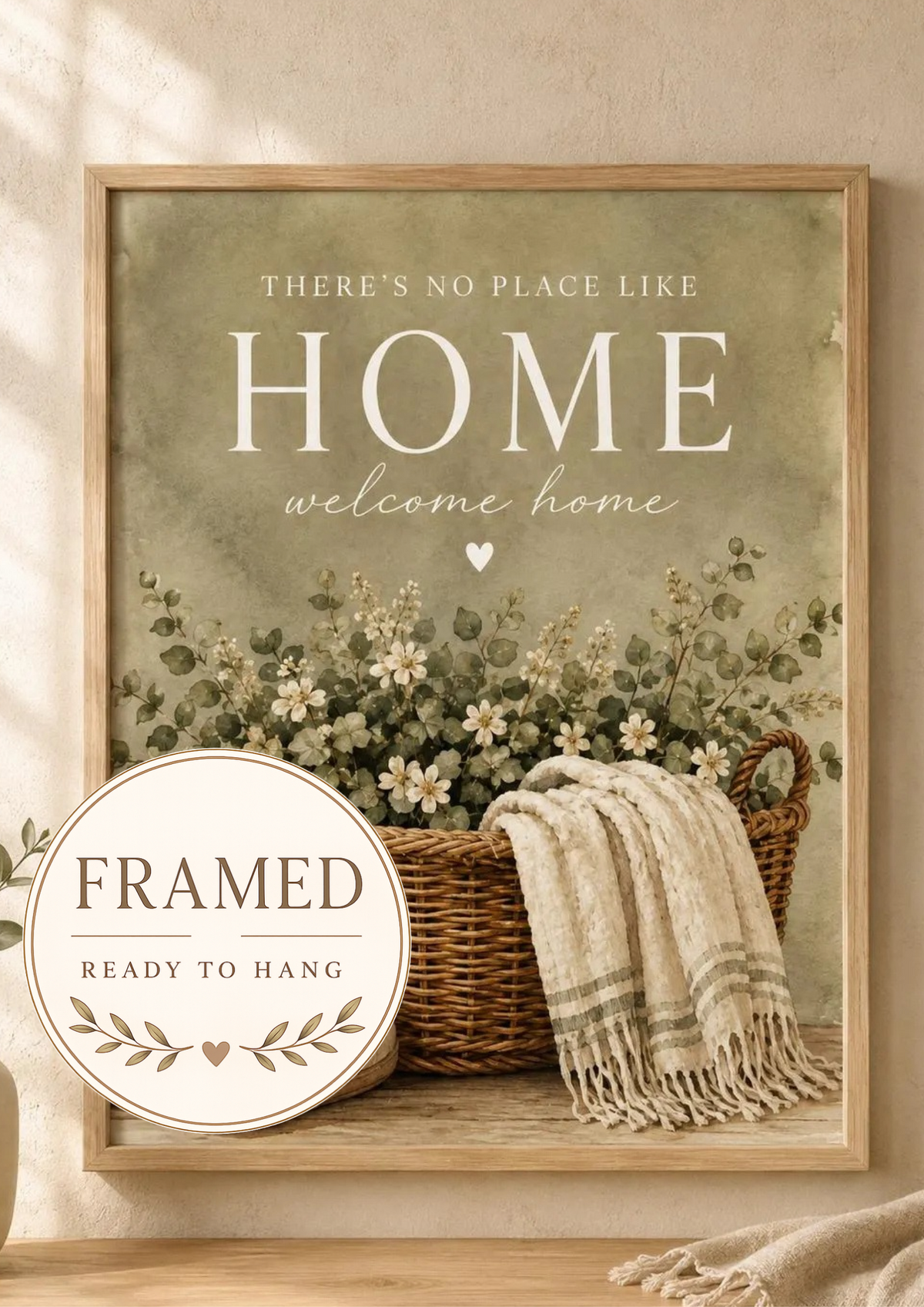 There's No Place Like Home and welcome home artwork with ivory flowers, foliage, wicker basket, cream throw and slippers; framed and ready to hang badge