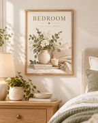 Bedroom rest reset dream quote with white flowers, sage foliage, ceramic vase, candle, books and soft neutral bedding; print only, frame not included