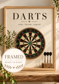 Vintage dartboard with Darts and aim, throw, repeat wording, rustic wood and greenery; framed and ready to hang badge