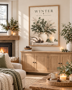 Winter soft snow, warm hearts artwork with snowy evergreens, eucalyptus, white berries, ceramic vase, knitted blanket, pine cones and candle styled in a living room