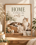 Home is where my cats are artwork with a cat sleeping in a woven basket and another sitting beside it, flowers, books, candle and knitted blankets; print only, frame not included
