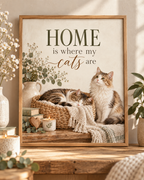 Home is where my cats are artwork with a cat sleeping in a woven basket and another sitting beside it, flowers, books, candle and knitted blankets; print only, frame not included