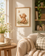 Watercolour teddy bear raising a paw towards a butterfly among daisies and soft foliage styled in a reading corner