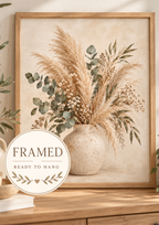 Neutral pampas grass, eucalyptus and tiny white flowers arranged in a rustic ceramic vase; framed and ready to hang badge