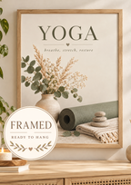 Yoga breathe stretch restore artwork with sage green yoga mat, eucalyptus, dried flowers, candle and stacked stones; framed and ready to hang badge