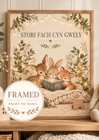Stori Fach Cyn Gwely Welsh bedtime story with fawn, rabbit and fox reading a book among soft woodland foliage; framed and ready to hang badge
