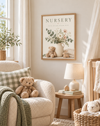 NURSERY little dreams bloom here artwork with cream and blush flowers, sage foliage, ceramic jug, teddy bear, wooden bunny and knitted blanket styled in a nursery reading corner