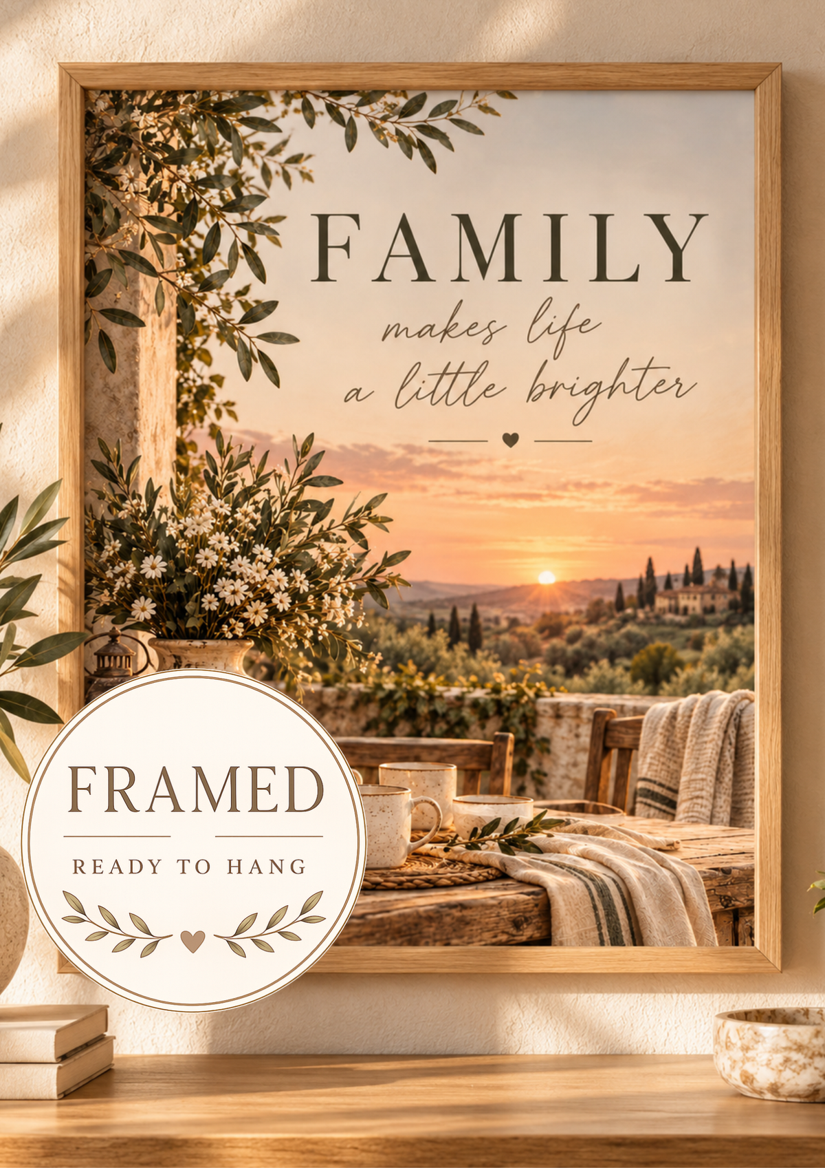 Family makes life a little brighter quote with Tuscan countryside sunset, olive greenery, white flowers, rustic ceramics and candlelight; framed and ready to hang badge