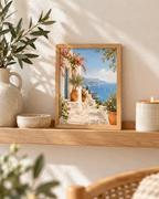Mediterranean coastal scene with pink bougainvillea, whitewashed walls, terracotta pots and blue sea styled in a shelf display