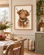Christmas Highland cow watercolour with tartan scarf, evergreen sprigs and red berries styled in a dining area