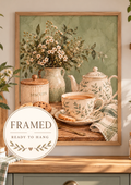 English tea and biscuits still life with floral teapot, matching teacup, cream flowers and sage-green background; framed and ready to hang badge