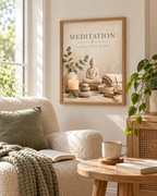 Buddha meditation artwork with eucalyptus, candle, stones and the words breathe, soften, be still beside a cosy armchair