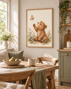 Watercolour teddy bear raising a paw towards a butterfly among daisies and soft foliage styled in a nursery