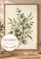 Sage green eucalyptus and delicate white blossom botanical watercolour against a warm cream background; framed and ready to hang badge