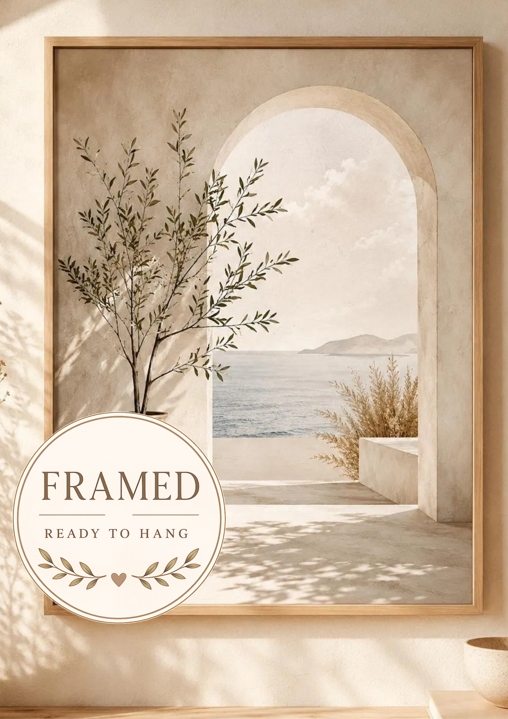 Mediterranean olive tree and stone archway overlooking a calm sea; framed and ready to hang badge