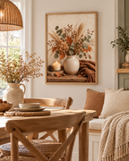 Autumn floral still life with dried hydrangeas, eucalyptus, copper leaves, rustic vase, candle, acorns and knitted throw styled in a dining area