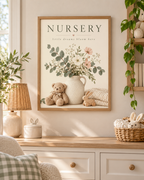 NURSERY little dreams bloom here artwork with cream and blush flowers, sage foliage, ceramic jug, teddy bear, wooden bunny and knitted blanket styled in a nursery dresser area