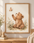 Watercolour teddy bear raising a paw towards a butterfly among daisies and soft foliage; print only, frame not included