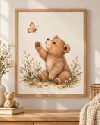 Watercolour teddy bear raising a paw towards a butterfly among daisies and soft foliage; print only, frame not included