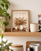 Autumn crisp air cosy moments artwork with dried flowers, eucalyptus and grasses in a rustic vase, candle and knitted blanket styled in a shelf