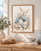 Coastal seashell artwork above a wooden console beside a blue bowl