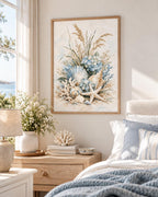 Coastal seashell artwork above a bed with soft blue bedding